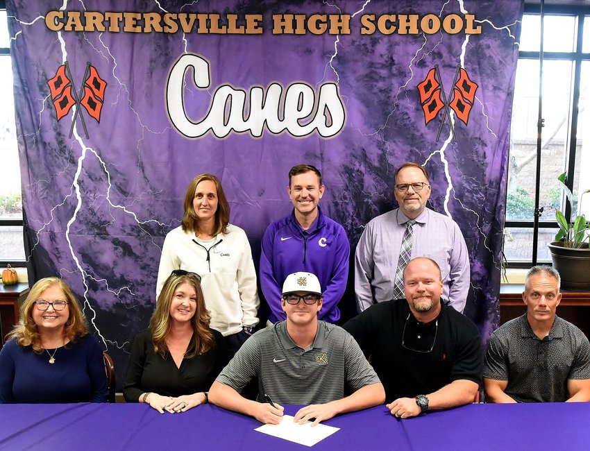 Cartersville High School's Caden Carroll, seated center, has signed with Kennesaw State. Joining him at the signing ceremony were were, (front row, from left): Cecilia Davis, grandmother; Julie Carroll, mother; Jay Carroll, father; and Todd Seigler, trainer.; (Back row) Shelley Tierce, CHS principal; Kyle Tucker, CHS head baseball coach; and Darrell Demastus, CHS athletic director.
