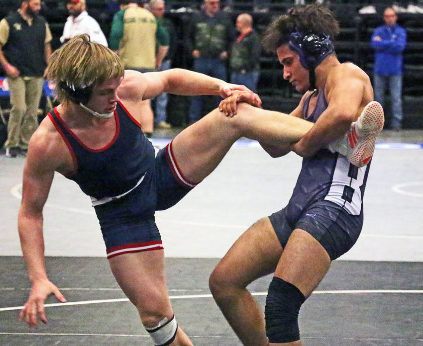 Blair 170-pounder Yoan Camejo, right, grabs the leg of Adam Central's Oaklyn Smith on Saturday in Kearney.