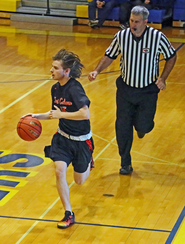The referee follows behind the play and Fort Calhoun sophomore Owen Newbold on Monday at Logan View High School.