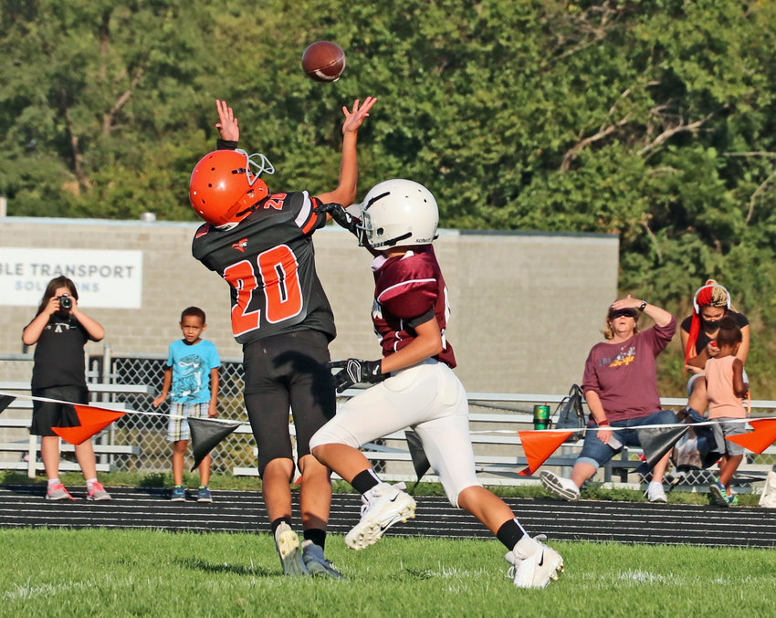 The Pioneers' Blake Welchert, left, can't quite reach a throw from his QB while Arlington's Kieryn Grothe defends Tuesday at Fort Calhoun High School.