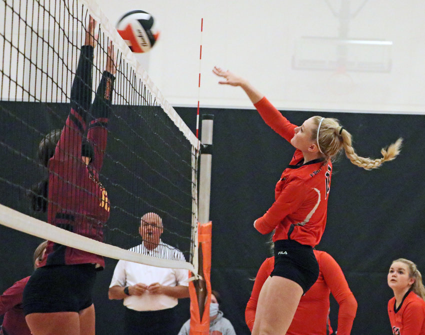 Pioneers sophomore Olivia Quinlan, right, spikes the ball over the net Saturday at Fort Calhoun High School.