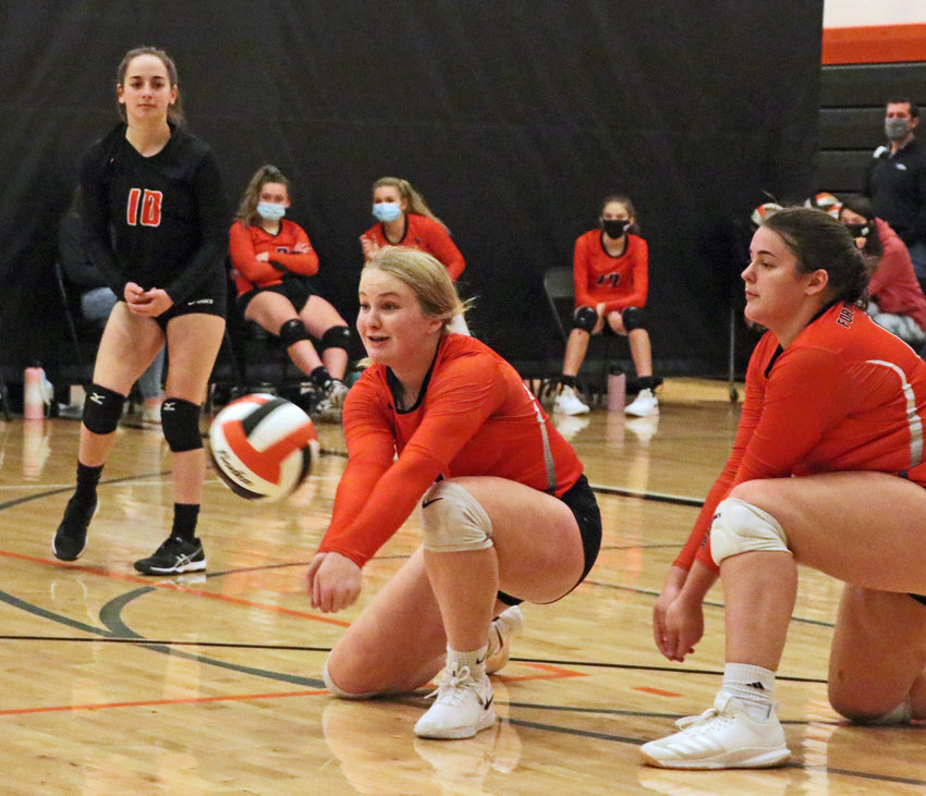 Pioneers freshman Raegen Wells makes a play on the ball while McKenna Greenwell, left, and Megan Johnson, right, keep an eye on things Saturday at Fort Calhoun High School.