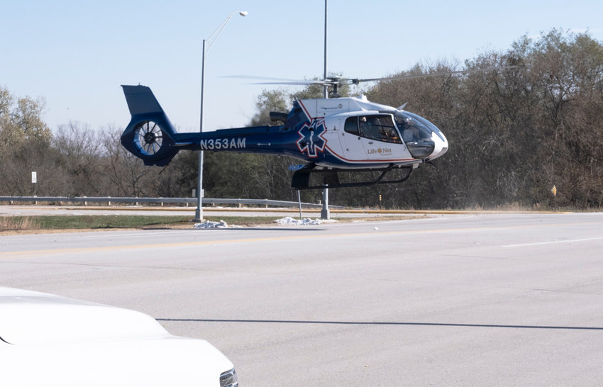 A helicopter lands on U.S. Highway 75 to transport a patient from a two-vehicle accident Tuesday south of Blair.