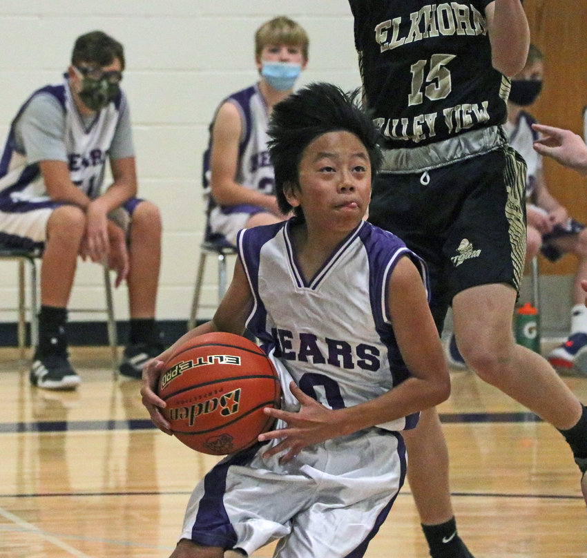 Bears eighth-grader Zeke Prochaska evades a leaping defender on his way to the bucket Monday at Otte Blair Middle School.