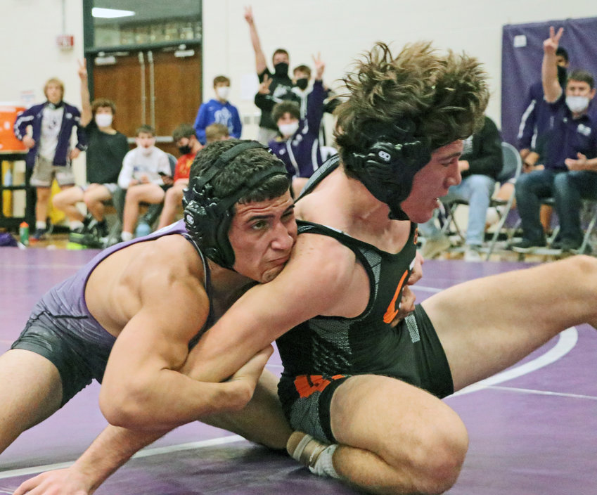 Bears 152-pounder Yoan Camejo, left, takes the back of Beatrice's Cole Maschmann on Friday at Blair High School.