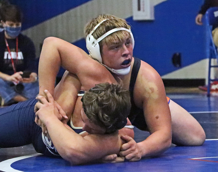Pioneers 220-pounder Jesse Hartline works to pin Elkhorn South's Dylan Wilson on Saturday at Bennington High School.