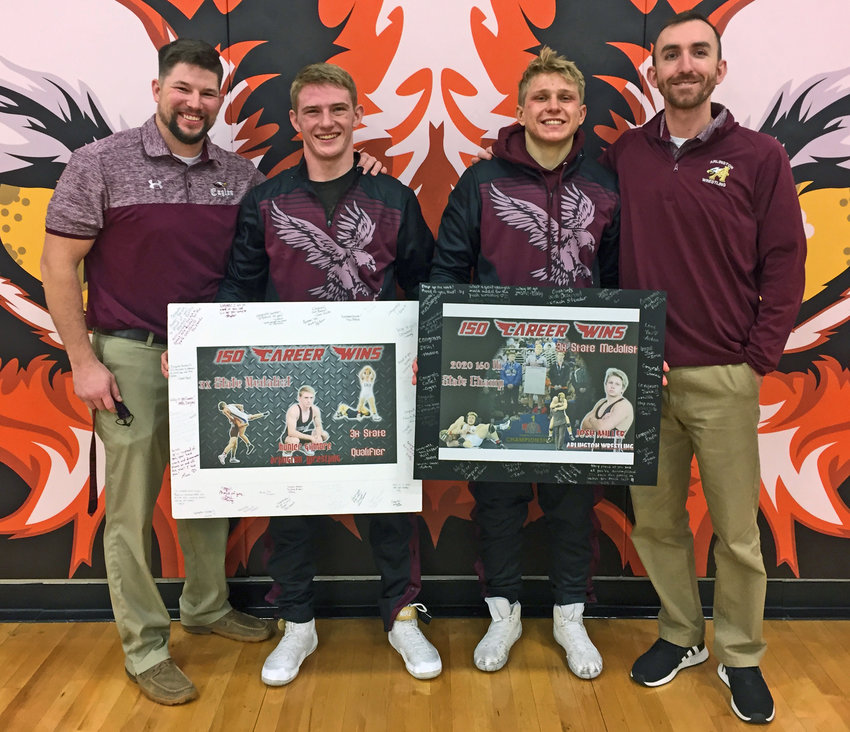 Hunter Gilmore, middle left, and Josh Miller, middle right, pose for a photo with Arlington wrestling coaches Doug Hart, left, and Tyler Stender after earning their 150th career wins Saturday at North Bend Central.