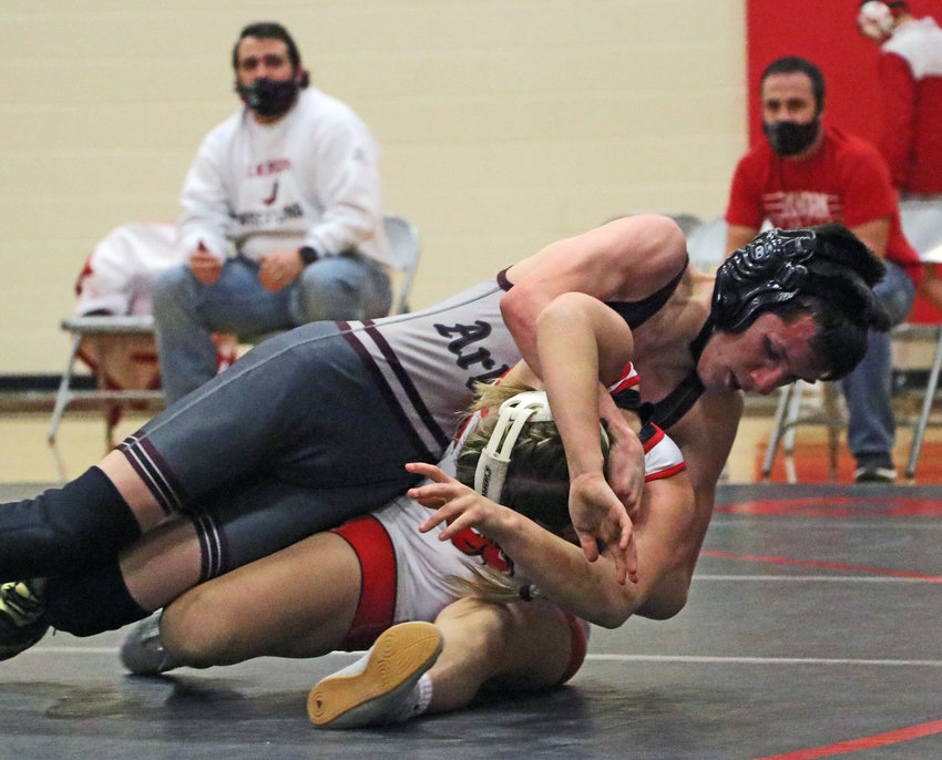 Arlington 106-pounder Trey Hill, top, wrestles the Antlers' Gabby Ladehoff Tuesday at Elkhorn High School.