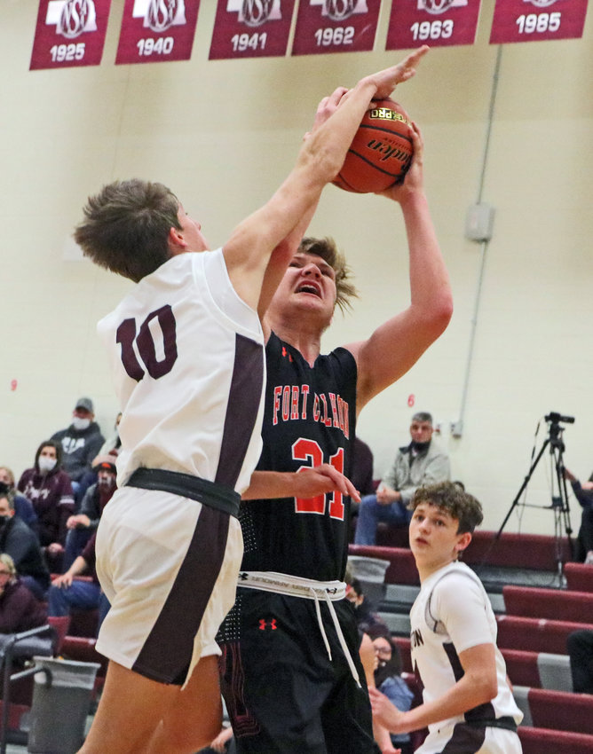 Eagles junior Colby Grefe, left, gets his hand on a shot by Fort Calhoun's Zane Schwarz on Thursday at Arlington High School.