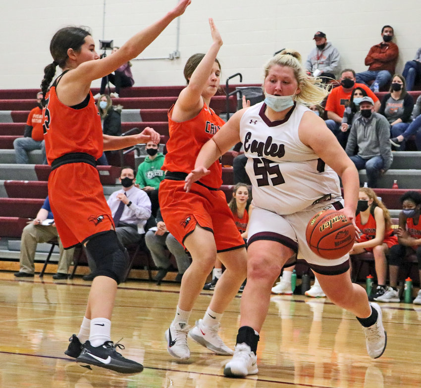 The Eagles' Hailey Brenn, right, dribbles by Fort Calhoun's Bria Bench, left, and Maddy Tinkham on Friday at Arlington High School.