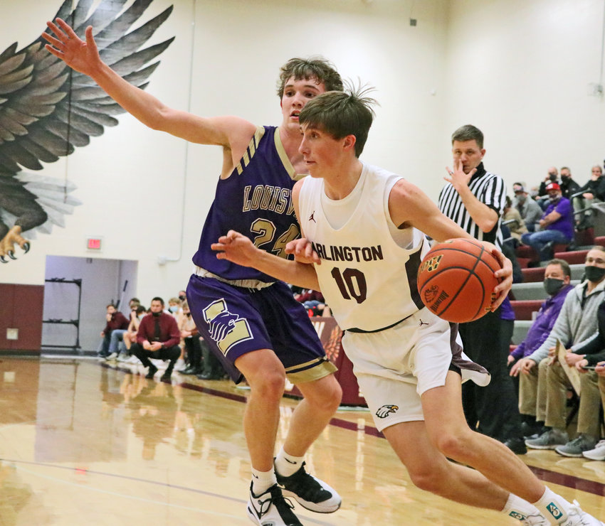 Eagles junior Colby Grefe, right, dribbles while defended by Louisville's Eric Heard on Friday at Arlington High School.