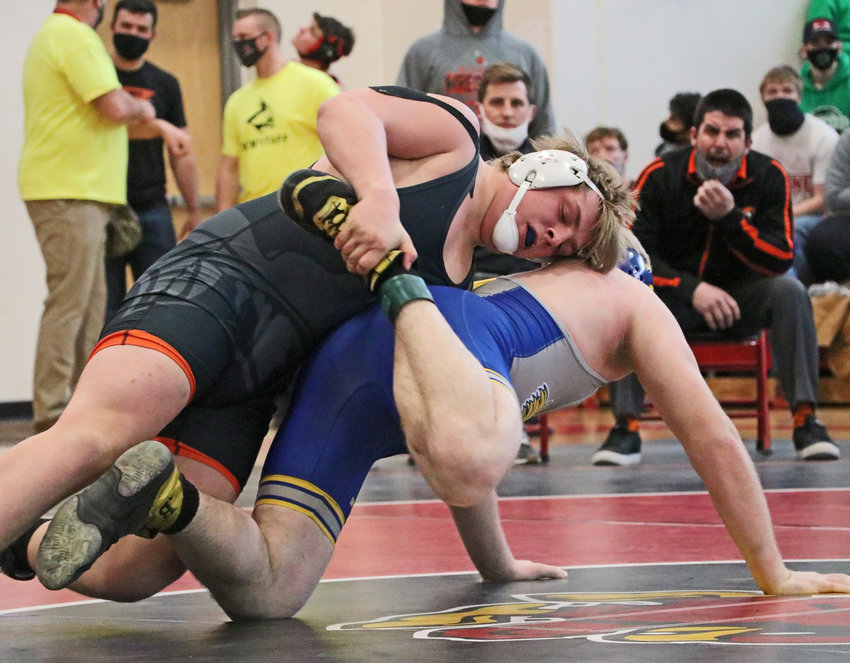 Fort Calhoun's Jesse Hartline, top, controls his opponent Saturday during district competition at Albion Boone Central.