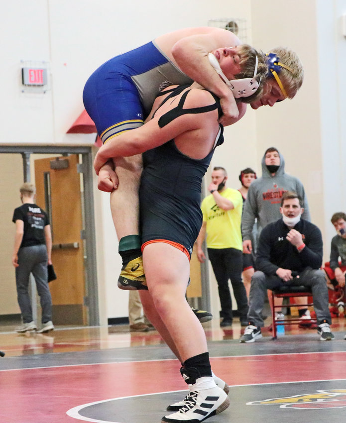Fort Calhoun 220-pounder Jesse Hartline picks up his St. Paul opponent Saturday during district competition at Albion Boone Central.