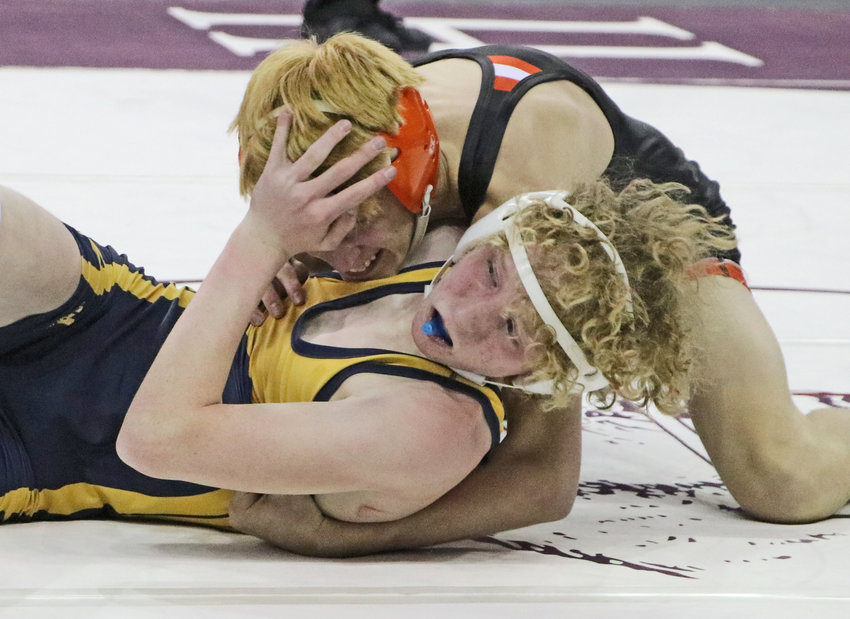 Fort Calhoun 113-pounder Ely Olberding, top, works to score back points against Raymond Central's Jacob Schultz on Friday in Omaha.