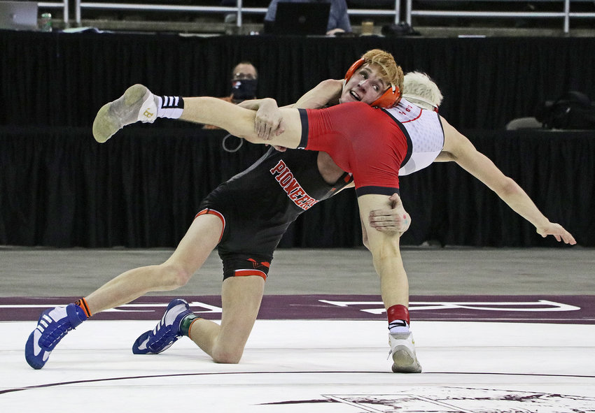 Fort Calhoun 113-pounder Ely Olberding, left, scores a takedown during the 2021 NSAA State Championships in Omaha.