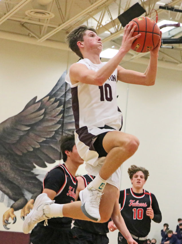 Eagles junior Colby Grefe glides to the rim for a layup Tuesday at Arlington High School.