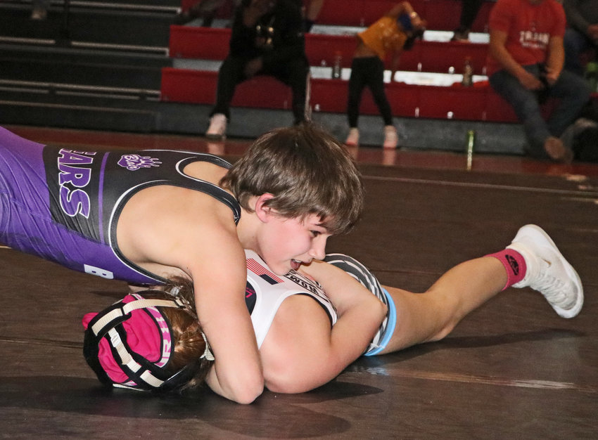 MWC Wrestling Academy's Hudson Loges of Blair, top, competes Saturday at the Gardner-Hawks Center.
