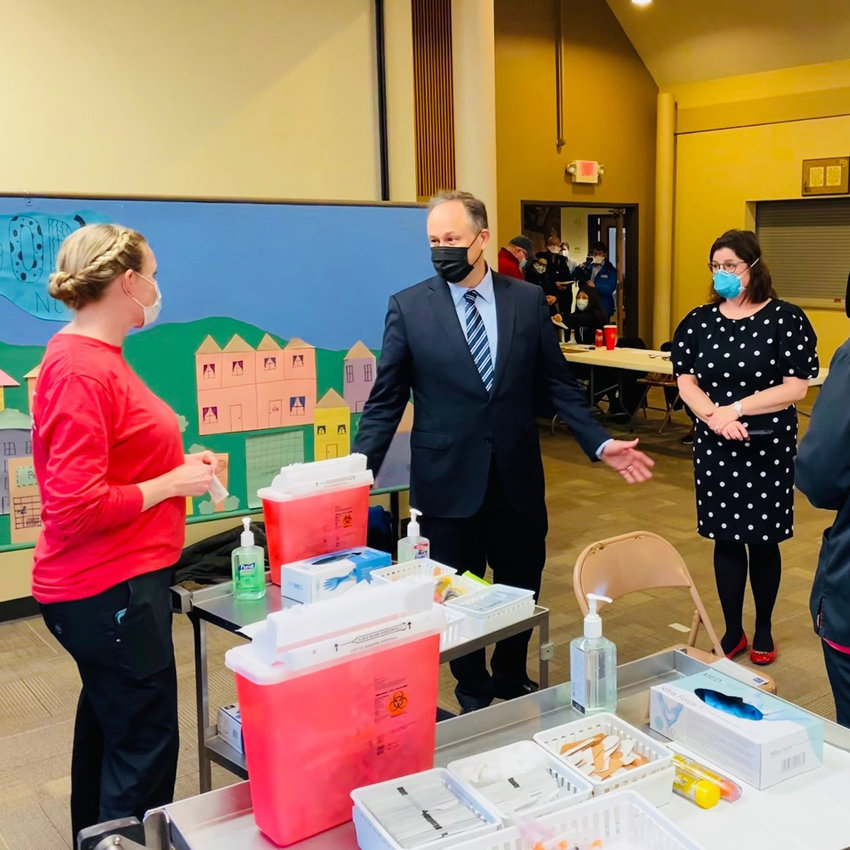 Second Gentleman Doug Emhoff speaks to a Three Rivers Public Health Department employee during a vaccination clinic Tuesday at First Lutheran Church in Blair.