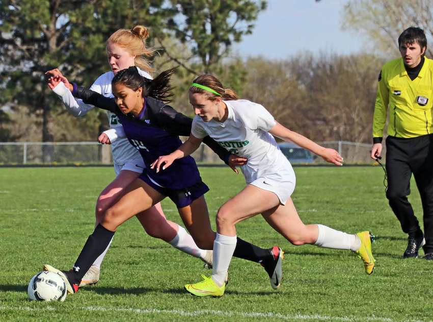 Blair sophomore Allison Hernandez, middle, battles for the ball with two Scotus defenders Tuesday at Krantz Field.