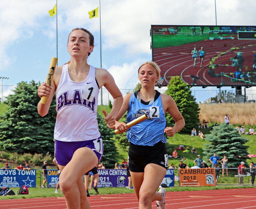 Blair Bear Reece Ewoldt, left, runs her leg of the 3,200-meter relay race Friday at Omaha Burke Stadium.