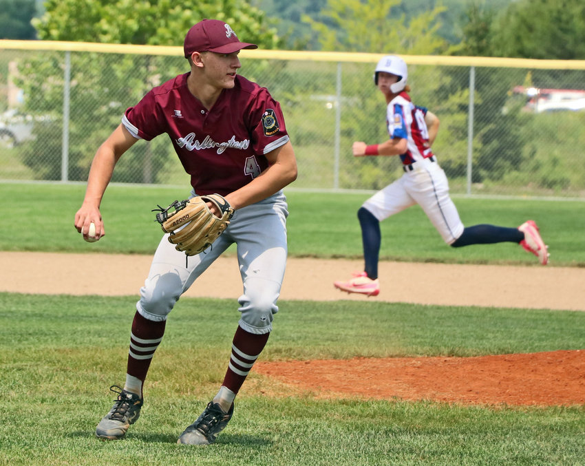 Arlington Junior Legion pitcher Trevor Denker looks to throw to first base for an out Monday against Blair during the Class B State Tournament in Waverly.