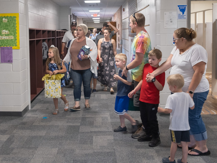 Students and family members find their way to classrooms at South Primary School during back-to-school night on Monday.