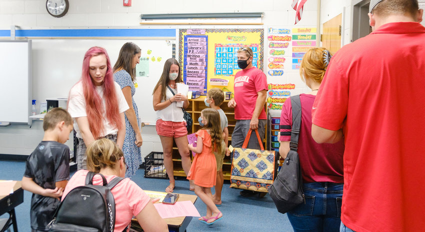 Second grade teacher Ashley Bacon meets students and family members during back-to-school night Monday at South Primary School.