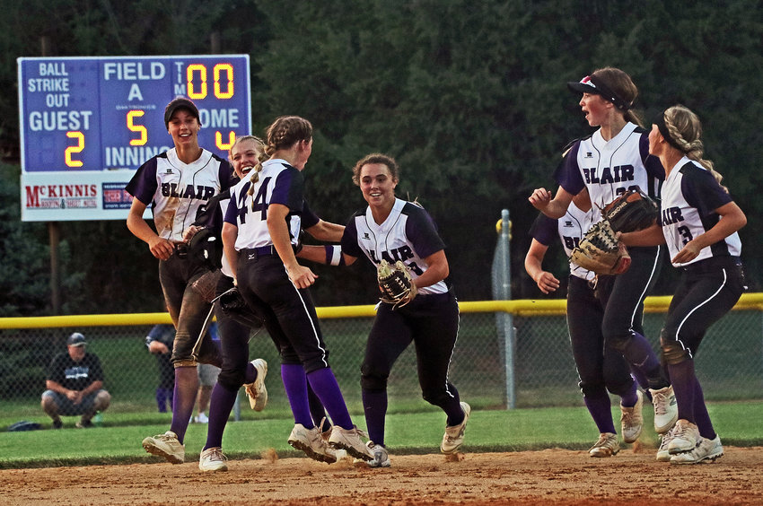 The Blair softball team celebrates with Cailey Anderson, middle, on Thursday after her diving catch in right field at the Youth Sports Complex.