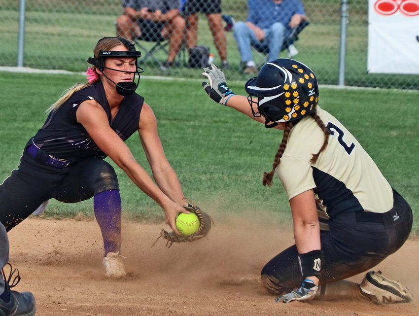 The Bears' Greta Galbraith, left, reaches to tag Fremont's Maggie McClain on Saturday at the Blair Youth Sports Coplex.