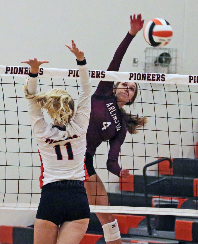 Arlington senior Kailynn Gubbels spikes the ball by the Pioneers' Olivia Quinlan on Thursday at Fort Calhoun High School. The Eagles bested FCHS 25-16, 25-11 and 25-22 in the season-opening match.