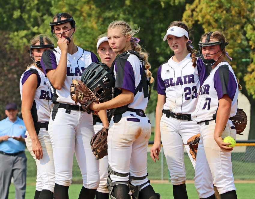 Blair's Greta Galbraith, from left, Tessa Villotta, Leah Chance, Nessa McMillen, Claire Mann and Brooke Janning look to the dugout for answers against Elkhorn on Saturday at the Youth Sports Complex.