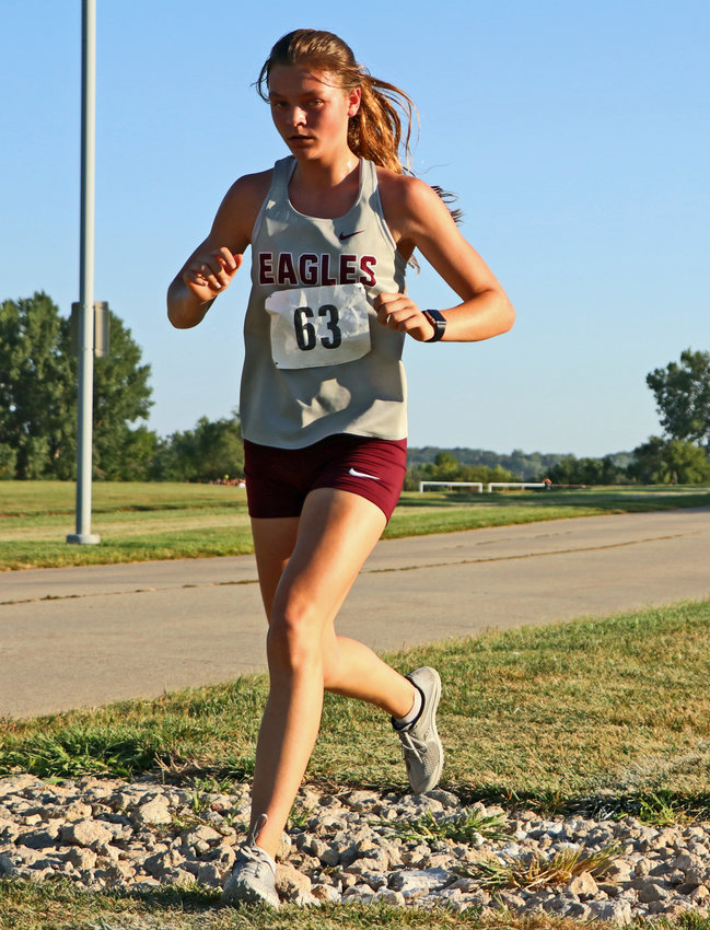 Arlington runner Hailey O'Daniel crosses over some rocks Thursday during the Blair XC Invitational.