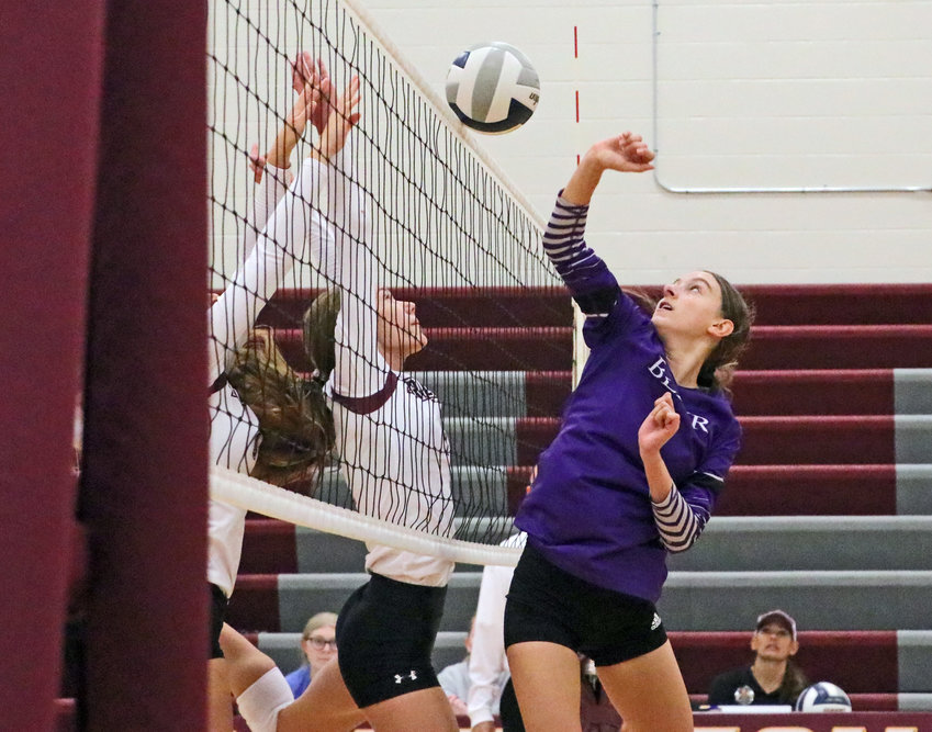 Blair sophomore Reece Ewoldt, right, meets the Eagles' Kailynn Gubbels at the net Saturday at Arlington High School.