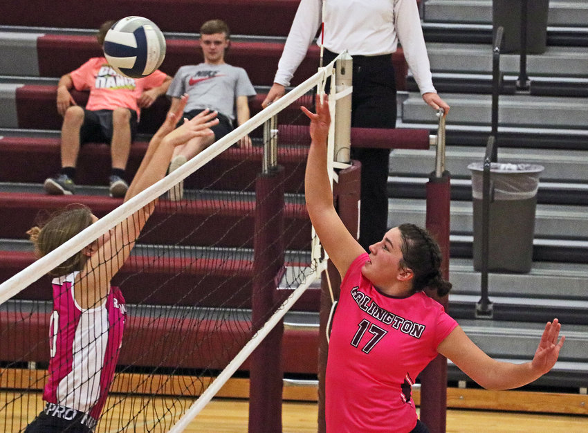 Eagles sophomore Taylor Arp, right, taps the ball over the net and a Raymond Central Mustang on Tuesday at Arlington High School.
