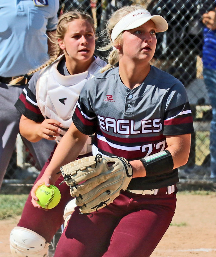 Arlington third baseman Hannah Stahlecker looks to throw to first with Cadie Robinson as her backup Friday in Malcolm.