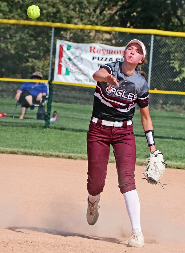 Arlington freshman Britt Nielsen throws to first base for an out Friday in Malcolm.