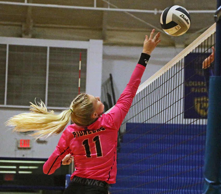 Fort Calhoun junior Olivia Quinlan taps the ball over the net Monday at Logan View High School.