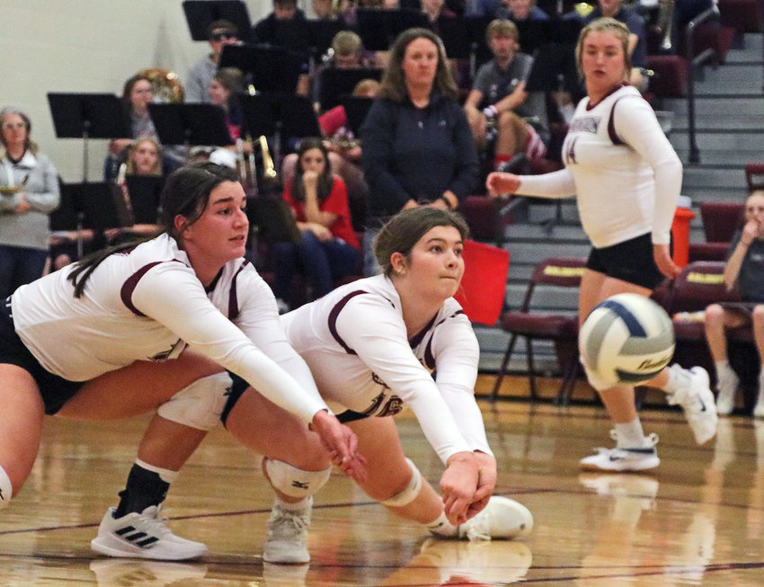Eagles Taylor Arp, left, and Kate Miller, middle, lunge for the ball as Cassidy Arp watches the play unfold Tuesday at Arlington High School.