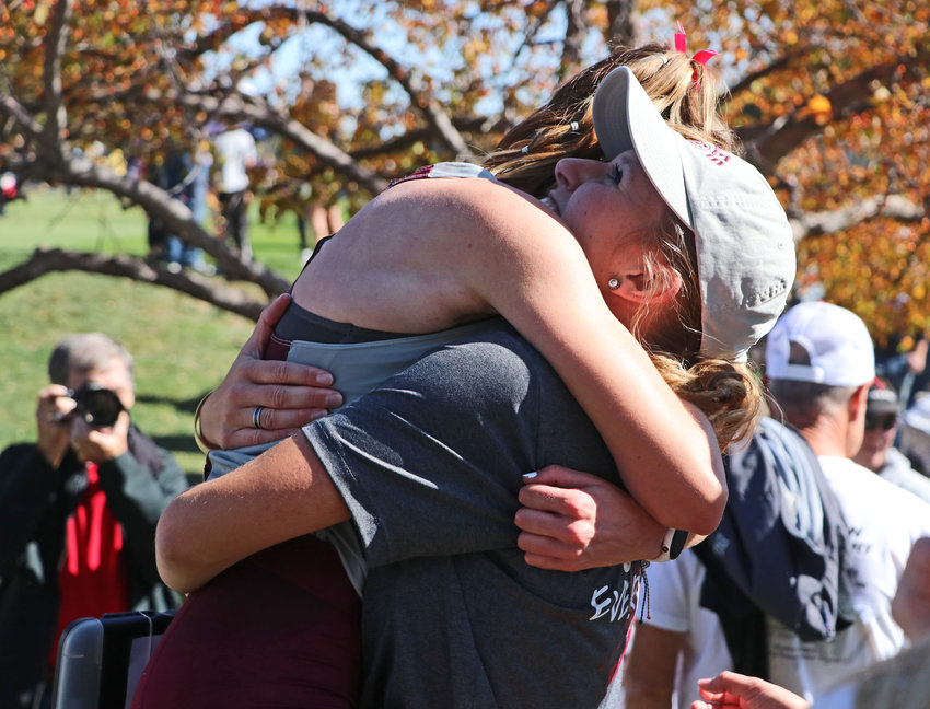 Arlington coach Michaela Curran embraces state champion Keelianne Green on Friday at Kearney Country Club.