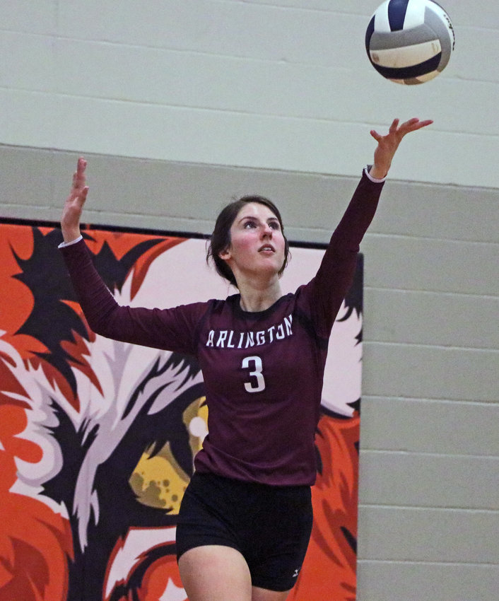 Arlington's Janessa Wakefield serves Monday at North Bend Central.