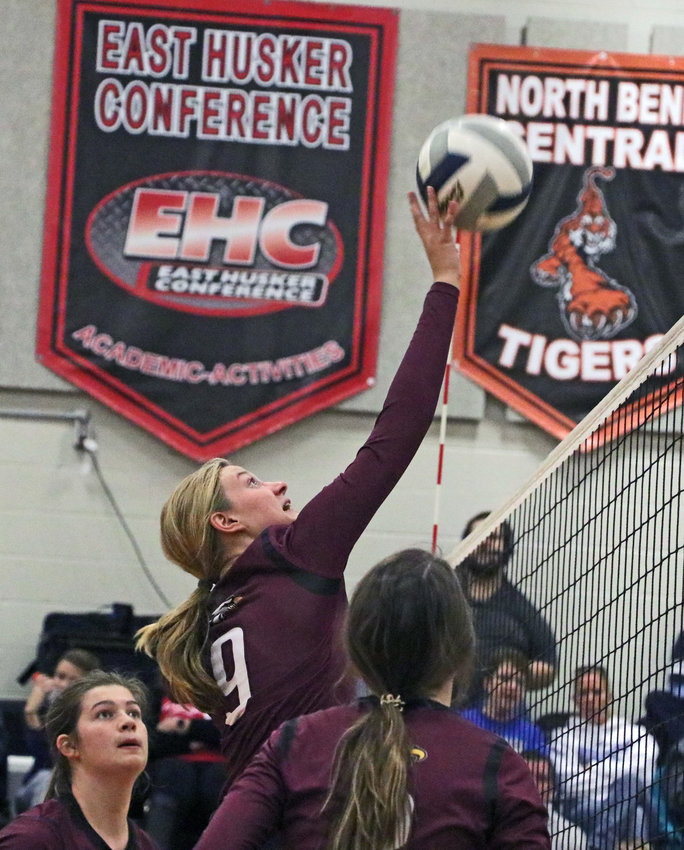 Arlington sophomore Lizzie Meyer tips the ball over the net Monday at North Bend Central.