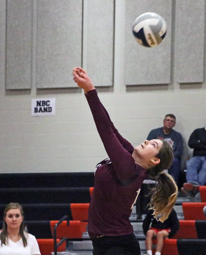 Arlington senior Kate Miller hits the ball over her head and the net Monday at North Bend Central.