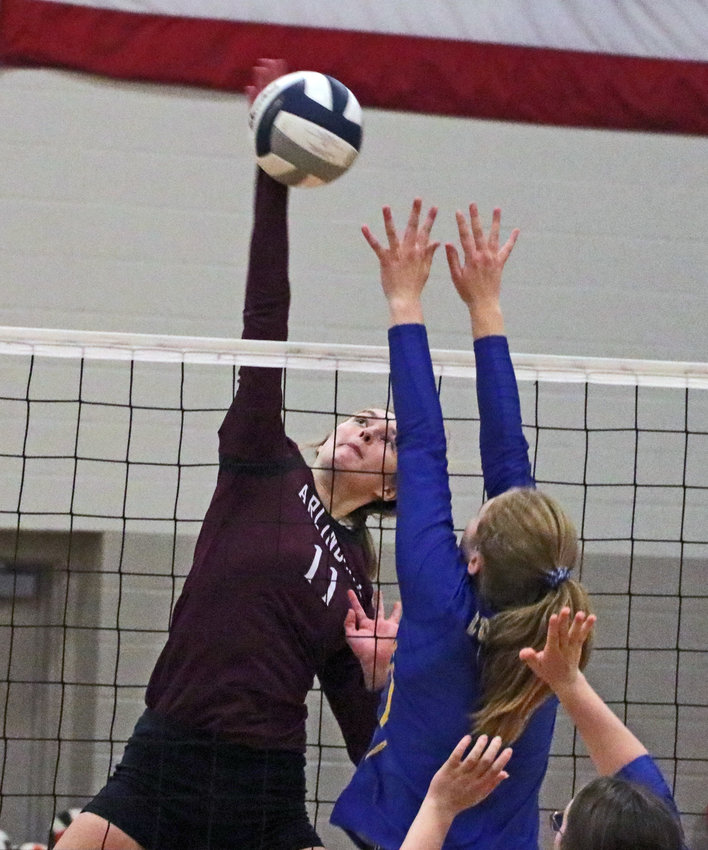 Arlington's Chase Andersen, left, spikes the ball against Logan View on Monday at North Bend Central.