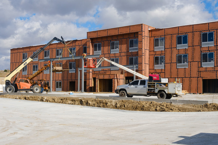 A construction crew sets a beam in place for the fascade of the new Holiday Inn Express in Blair.