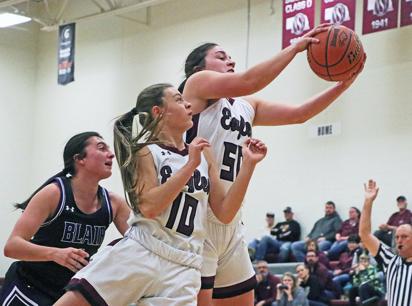 Arlington sophomore Taylor Arp, right, grabs a rebound in front of teammate Hailey O'Daniel, middle, and Blair's Maggie Valasek on Monday at Arlington High School.