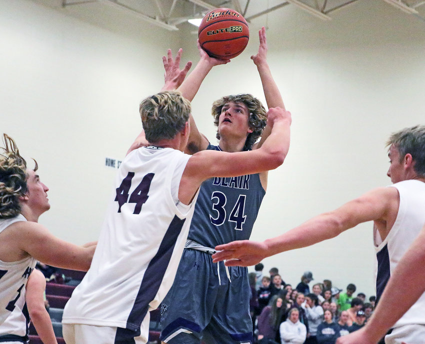 Blair junior Kade Ryden shoots the ball over Eagle Weston Wollberg on Monday at Arlington High School.