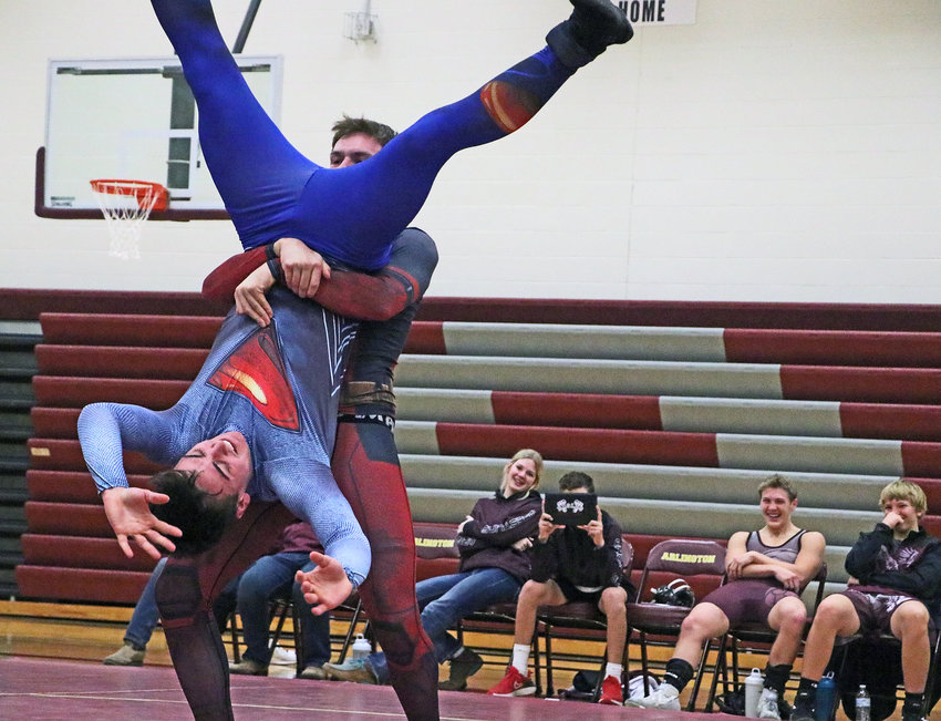 Deadpool — Ian Buckley — picks up Superman — Cade Podany — on Tuesday during the Arlington High School wrestling team's Superhero Showdown scrimmage.
