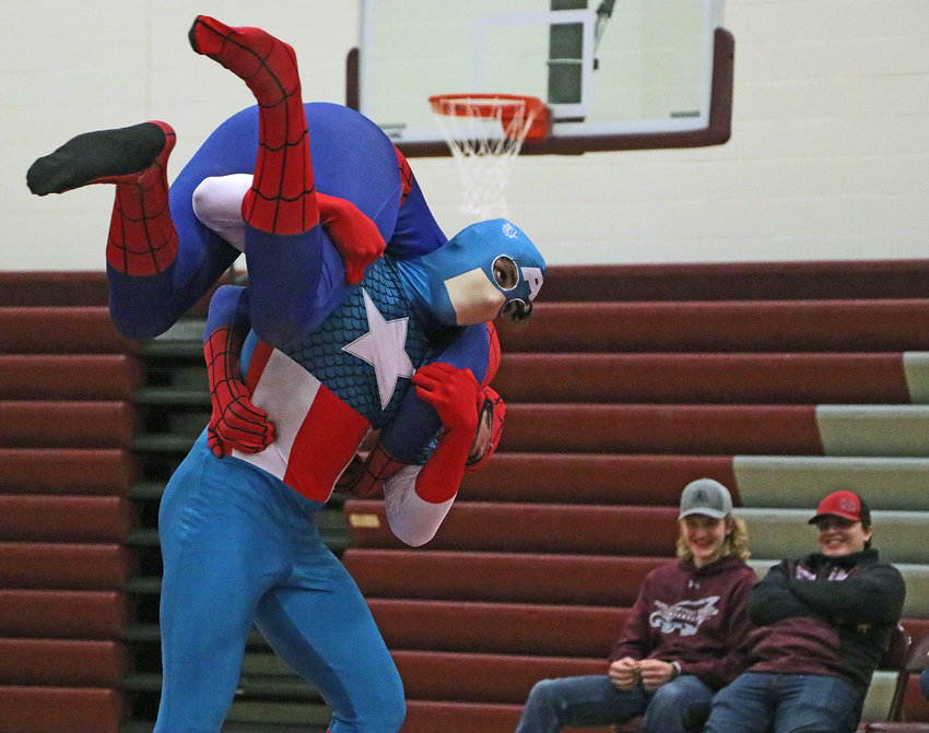 Captain America — Izzy Sanchez — carries around Spiderman — Kolton Gilmore — on Tuesday at Arlington High School.