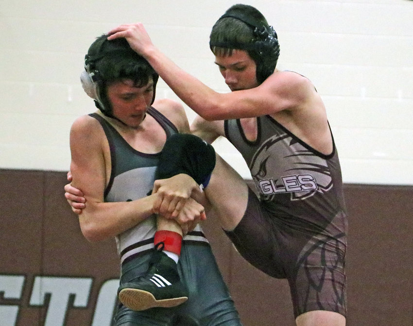 Aiden McDuffee, left, grapples with Trey Hill on Tuesday at Arlington High School.