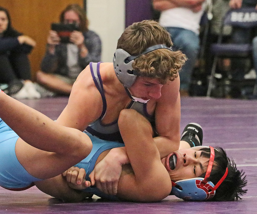Bears 120-pounder Jesse Loges, top, works to pin Ralston's Kevin Nguyenduy on Friday at Blair High School.
